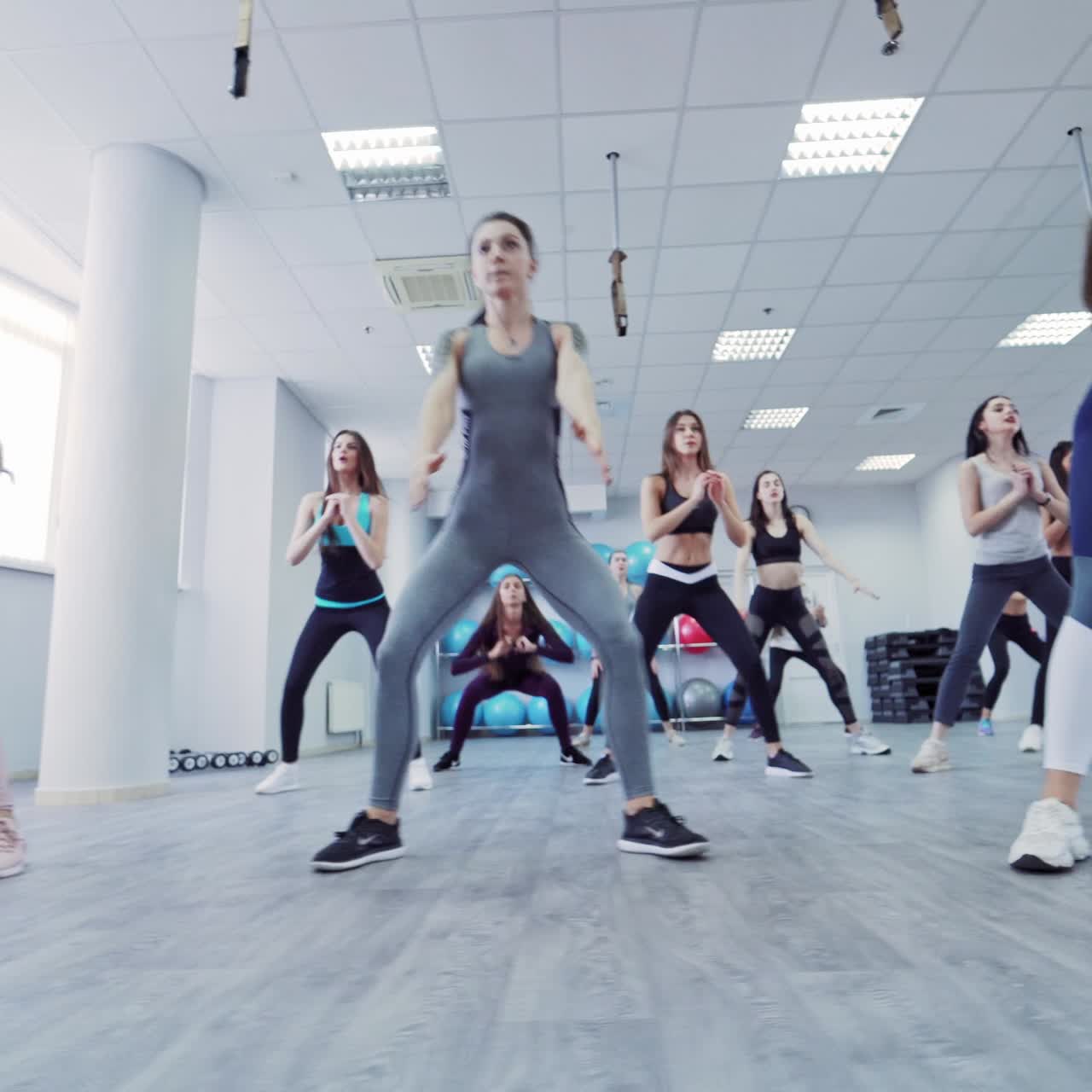 Group of sportive people at gym training