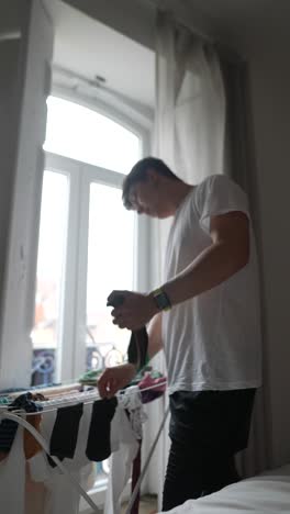person drying clothes at home