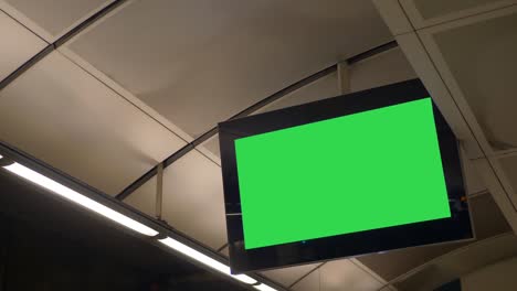 blank green screen flat screen monitor advertisement screen in train station