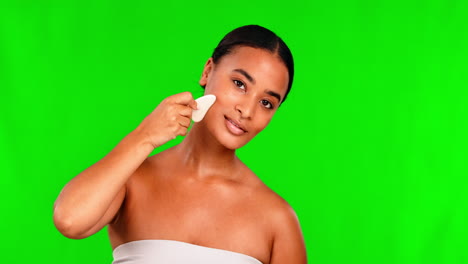 woman, green screen and gua sha for face massage