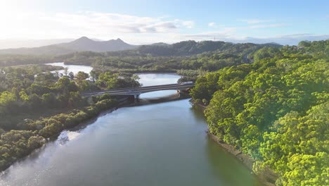 aerial view of river, bridge, and lush landscape