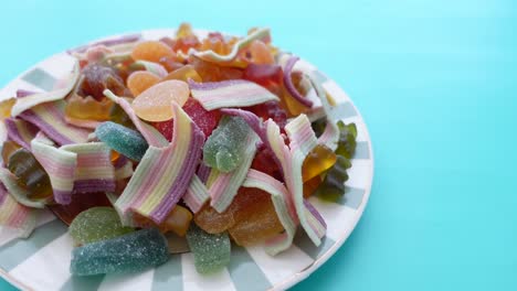 assorted colorful candies on a striped plate
