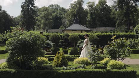 lovely newlyweds caucasian bride meeting groom with bouquet in park making kiss, wedding couple