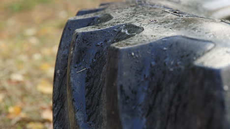 Macro-Shot-Of-Wet-Tractor-Tire-On-The-Ground-As-Obstacle