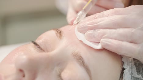 cosmetologist performing facial injection procedure