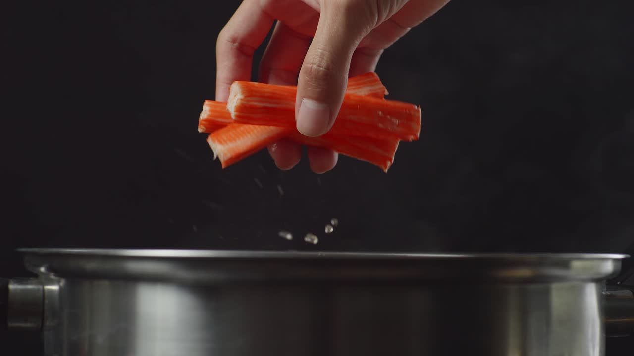 añadiendo palos de cangrejo a una olla