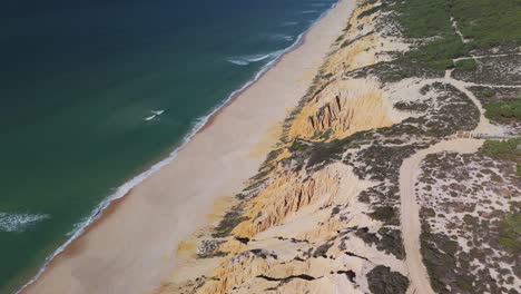 sandy beach and rugged coastline on atlantic coast in portugal