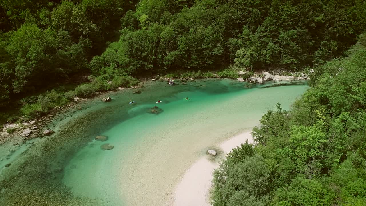 Aerial view of a group doing water rafting on the rapids at Soca River.