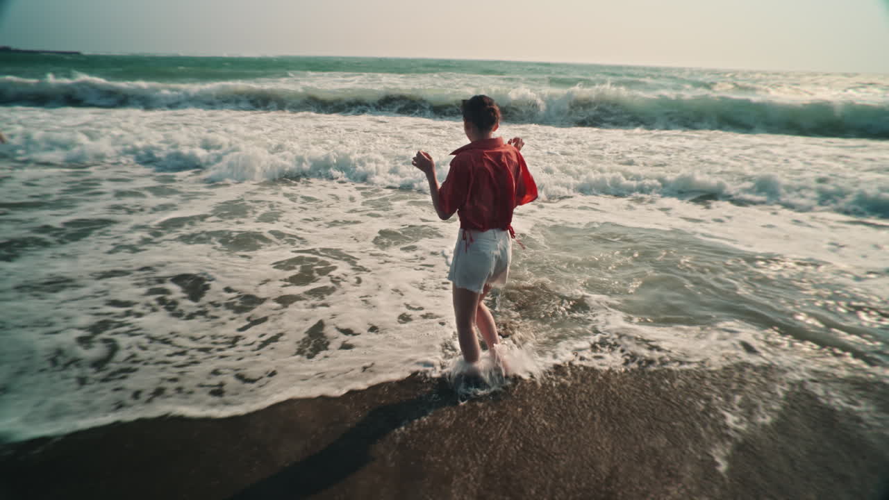 Woman on the beach with waves