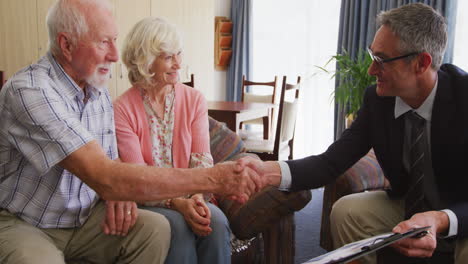 senior couple talking with a business man in retirement house