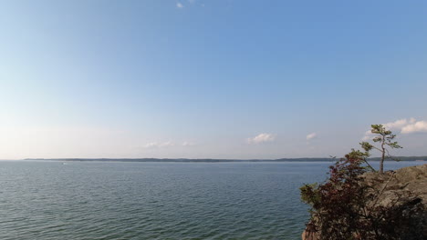 timelapse of blue sky ocean scene, breeze blowing, calm blue water