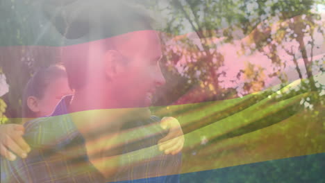 animation of germany flag over caucasian man giving a piggyback ride to his daughter in garden