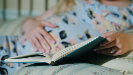 Pregnant-Woman-Reads-A-Book-In-Her-Bed-Close-Up-Shot