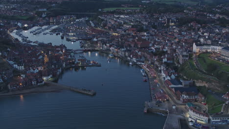north york moors, whitby harbour, drone over river esk at dawn blue hour