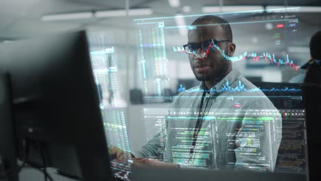 futuristic office with hologram screens concept: portrait of professional black it specialist working on desktop computer with holographic projection showing stock market information, big data, charts