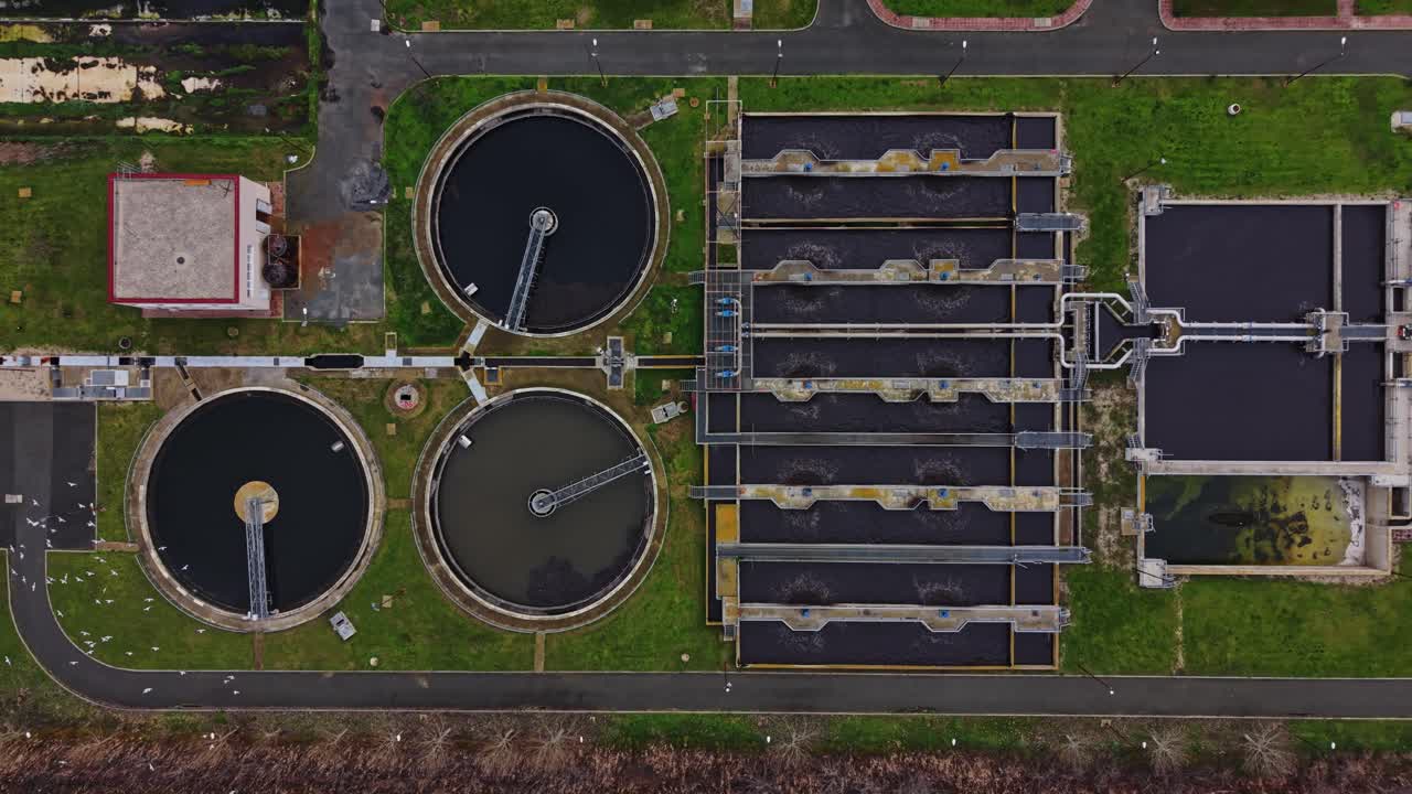 View of a water treatment plant with large tanks and processing areas