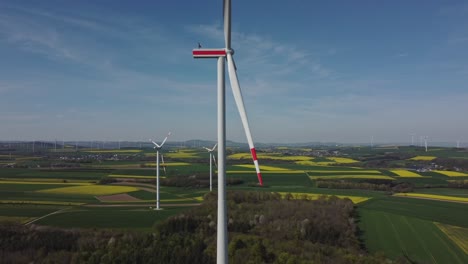 Wind-Turbine-Construction-In-Scenic-Fields---aerial-drone-shot-arc