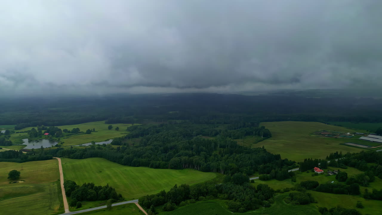 Aerial View of Rural Landscape with Fields and Forests Under Overcast Sky