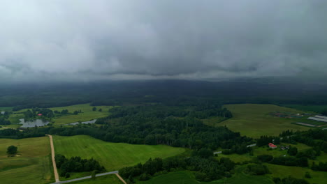 aerial view of rural landscape with fields and forests under overcast sky