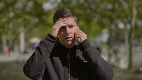 thoughtful man talking by smartphone outdoor