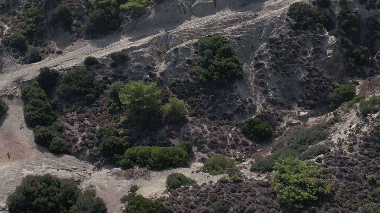 Beautiful aerial view of rocky terrain and green shrubs in Greece