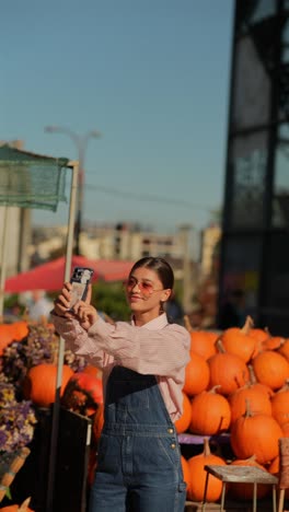 woman taking a selfie at a pumpkin patch