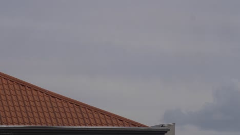 a corner of the building obscure the clouds and appear to be generated from behind the building