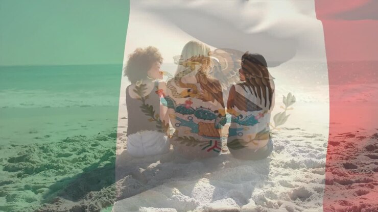 Una coppia seduta in spiaggia che si rilassa con un'animazione della bandiera messicana sovrapposta alla scena.