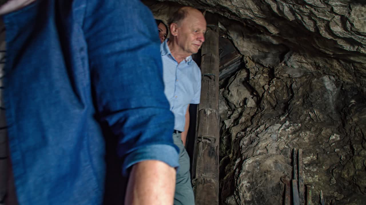 People walk inside close mine tunnel, Crna na Koroskem, Slovenia, slomo