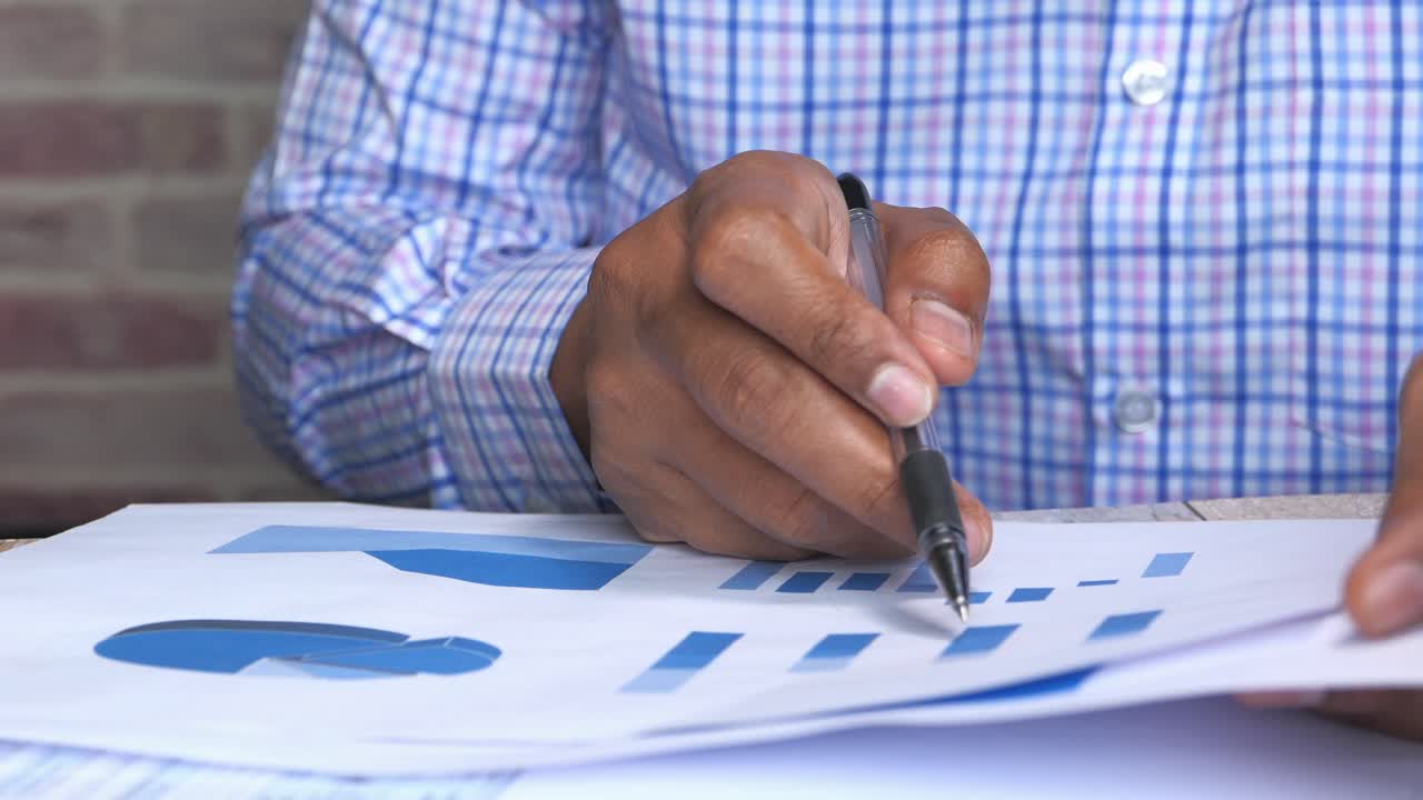 Business Person Reviewing Charts and Graphs