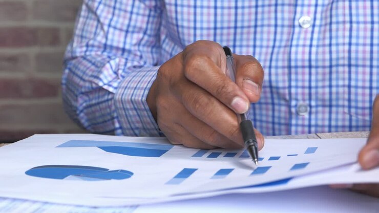 Business Person Reviewing Charts and Graphs