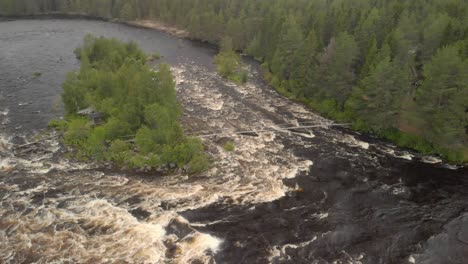 Aerial-footage-by-drone-of-two-men-walking-over-small-bridge-over-kalix-rapid