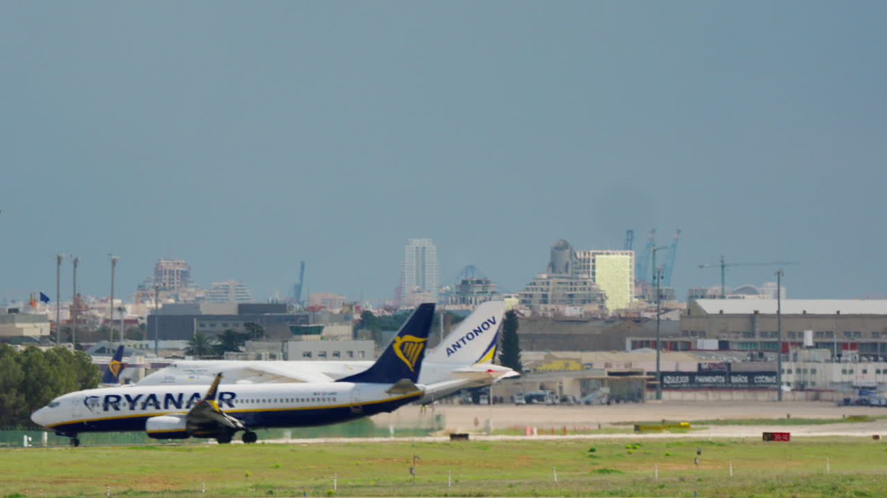 Aereo passeggeri Ryanair in rullaggio oltre un aereo cargo Antonov all'aeroporto
