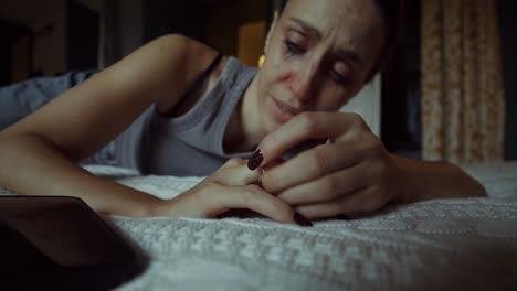 woman crying on bed