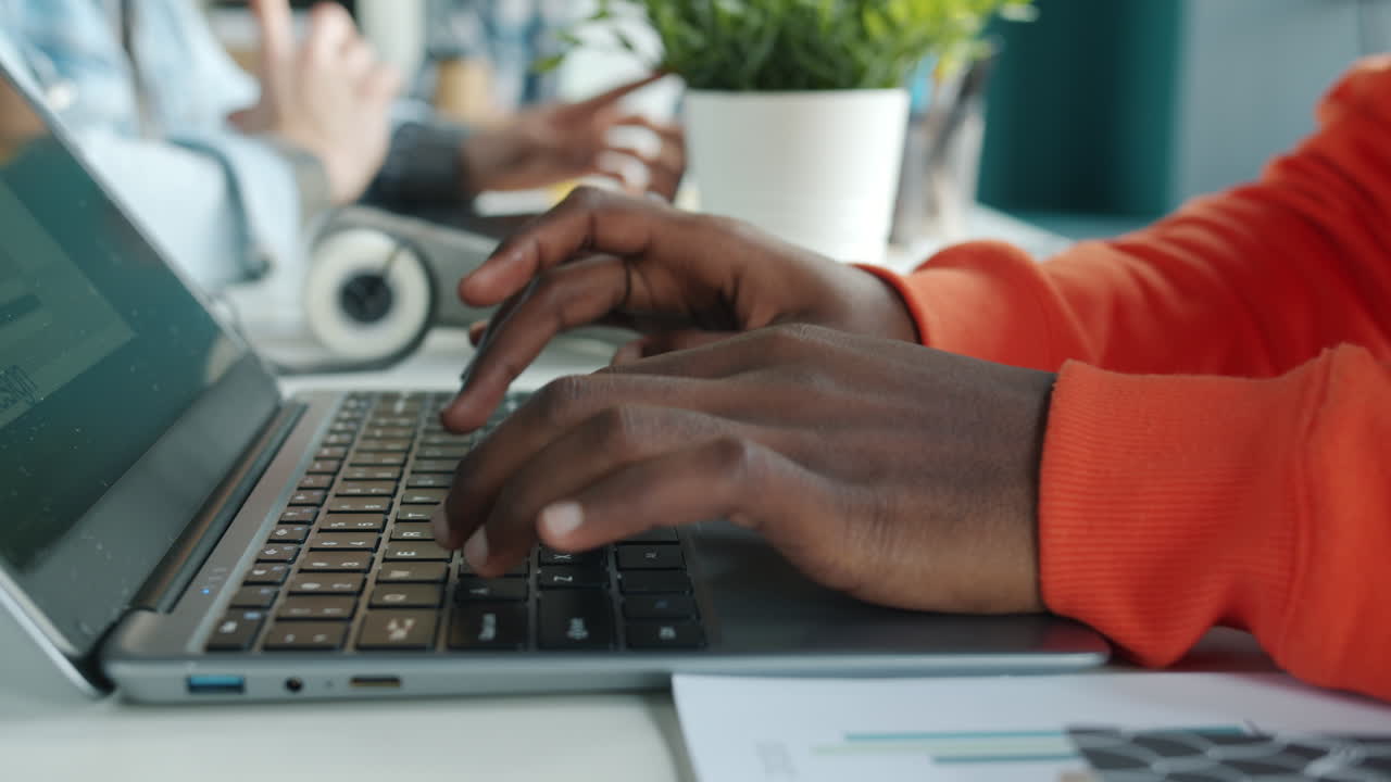People working on laptops in an office setting
