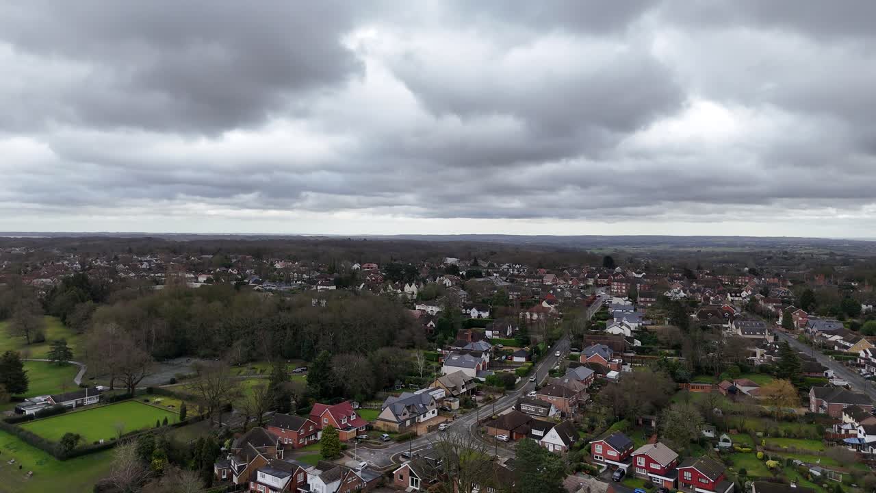 Billericay Essex ,UK housing estate ascending drone,aerial storm clouds overhead