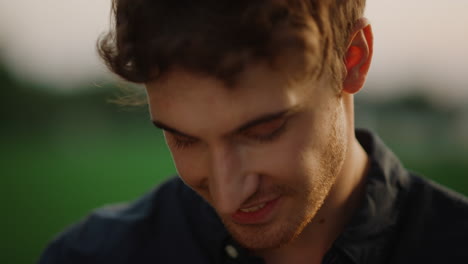 handsome man flirting with camera outdoors. portrait of sexy model guy