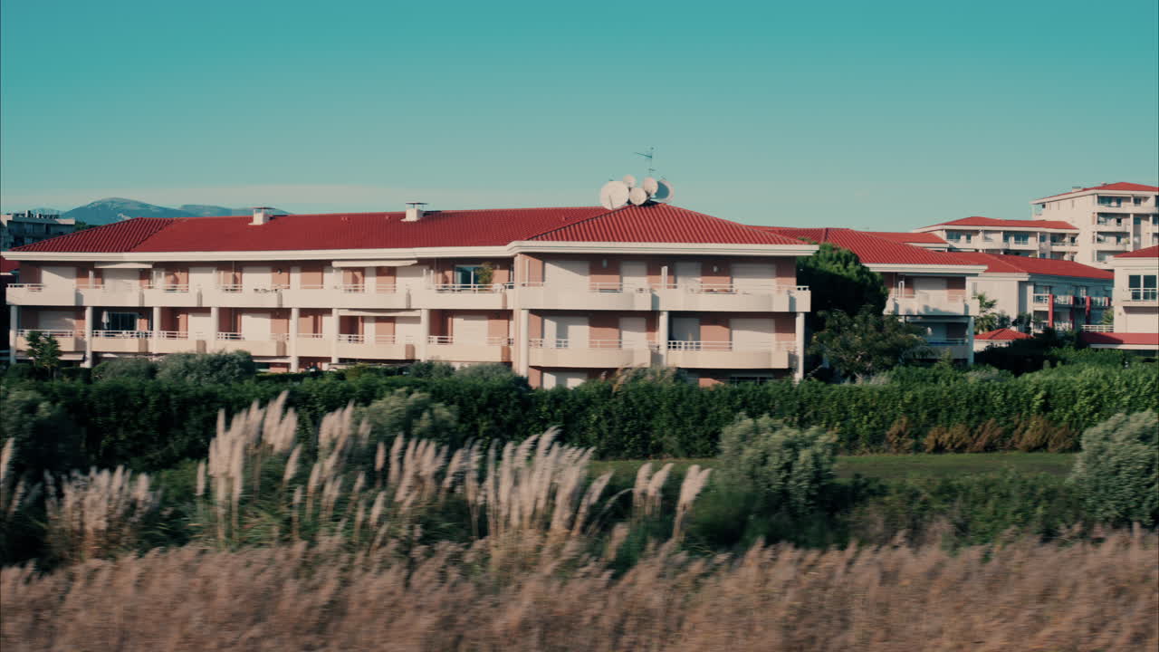 View from a moving train of the houses in Antibes, France