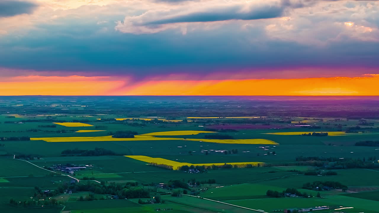 Drone hyperlapse of storm clouds, sunset and rain showers over agricultural landscape
