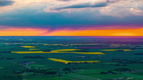 drone hyperlapse of storm clouds, sunset and rain showers over agricultural landscape
