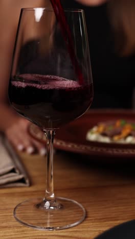 pouring red wine at a restaurant