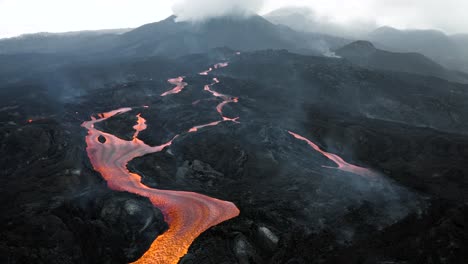 drone flying backwards and revealing lava streams from the cumbre vieja volcano