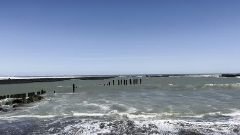 tidal waves crashing on the shore of patea beach in mana bay, taranaki region, new zealand
