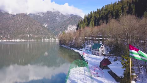 snowy mountain lake with cabin