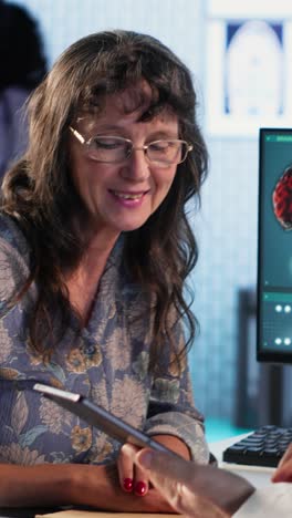 vertical video general practitioner consults old female patient about diagnostic test results