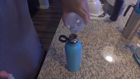 filling a thermos flask with water