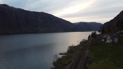 Late-evening-aerial-Sorfjorden-Vestland---Showing-railway-Bergensbanen-and-future-rock-dumping-spot-for-k5-road