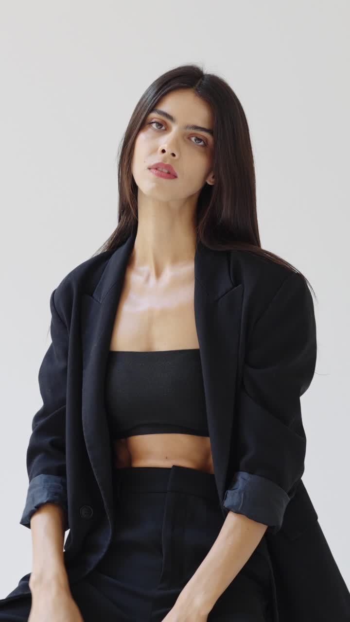 Woman in black blazer and tube top