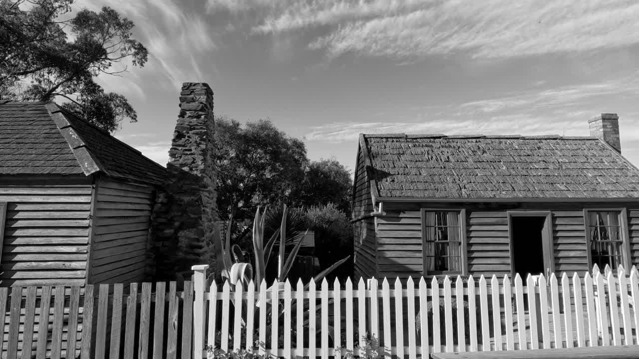 Old wooden house with white picket fence