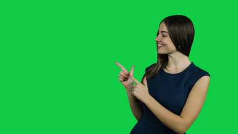 Happy-excited-girl-pointing-promoting-in-front-of-the-green-screen